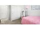 Bright bedroom with white closet doors and a cozy, pink-themed decor for a warm and inviting atmosphere at 3074 Kestrel St, Brighton, CO 80601