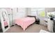 Cozy bedroom with plush pink blanket and natural light at 3074 Kestrel St, Brighton, CO 80601