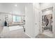 Bright entryway featuring a half bathroom and a view into the spacious living room at 3074 Kestrel St, Brighton, CO 80601
