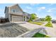 Beautiful two-story home with a wide driveway, manicured landscaping, and a charming front porch at 3074 Kestrel St, Brighton, CO 80601