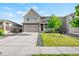 Charming two-story home with a well-manicured lawn and a two-car garage, curb appeal at 3074 Kestrel St, Brighton, CO 80601