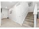 Neutral hallway featuring stairs leading to the upper level and white doors at 3074 Kestrel St, Brighton, CO 80601