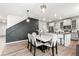 Open-concept kitchen and dining area featuring stylish decor, including a black accent wall and modern lighting at 3074 Kestrel St, Brighton, CO 80601