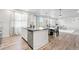 Open-concept kitchen with an island, modern appliances, and adjacent dining/living areas at 3074 Kestrel St, Brighton, CO 80601