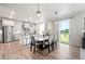 Bright kitchen features stainless steel appliances, granite countertops, and an adjacent dining area with backyard access at 3074 Kestrel St, Brighton, CO 80601