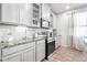 Kitchen with granite countertops, stainless steel appliances, and white cabinetry at 3074 Kestrel St, Brighton, CO 80601
