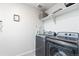 Modern laundry room featuring new washer and dryer, shelving, and decor at 3074 Kestrel St, Brighton, CO 80601