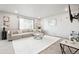 Bright and airy living room with plush carpeting, a comfortable sectional sofa, and stylish decor at 3074 Kestrel St, Brighton, CO 80601