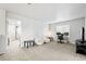 Spacious living room with plush seating, a dedicated workspace, and ample natural light for a comfortable and functional area at 3074 Kestrel St, Brighton, CO 80601