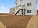 Backyard view of a home with a deck and walkout basement and a graded lot awaiting landscaping at 17120 E 90Th Pl, Commerce City, CO 80022