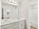 Bathroom featuring double sinks, and white cabinetry with a view of the shower at 17120 E 90Th Pl, Commerce City, CO 80022