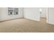 This bedroom has neutral colored carpet, large windows, and light-colored walls at 17120 E 90Th Pl, Commerce City, CO 80022