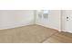 Neutral bedroom with tan carpet, window with blinds, white walls and light colored hardwood flooring at 17120 E 90Th Pl, Commerce City, CO 80022