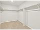 Spacious walk-in closet with ample shelving and neutral carpet at 17120 E 90Th Pl, Commerce City, CO 80022