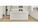 Kitchen island with sink and white countertops, stainless steel appliances and modern cabinetry at 17120 E 90Th Pl, Commerce City, CO 80022