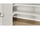 A staircase with open shelving with wooden floors and white wall at 17120 E 90Th Pl, Commerce City, CO 80022