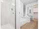 Well-lit bathroom with white subway tile, tub, and glass shower at 1470 S Quebec Way # 83, Denver, CO 80231