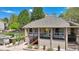Exterior shot of the community clubhouse, showcasing brick columns, a covered entrance, and professional landscaping at 1470 S Quebec Way # 83, Denver, CO 80231