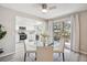Bright dining area features modern lighting, table and chairs, plus deck access and kitchen view at 1470 S Quebec Way # 83, Denver, CO 80231