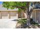 Charming brick townhome featuring a two-car garage, quaint front yard, and mature shade tree at 1470 S Quebec Way # 83, Denver, CO 80231