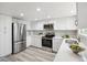 Modern kitchen featuring stainless steel appliances, white cabinets, and sleek countertops at 1470 S Quebec Way # 83, Denver, CO 80231