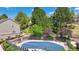Community pool with a safety cover, surrounded by lounge chairs and mature landscaping at 1470 S Quebec Way # 83, Denver, CO 80231