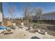 Backyard with a concrete patio, chairs, and space for outdoor activities surrounded by a wooden fence at 9615 Lansing Cir, Commerce City, CO 80022