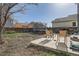 Backyard featuring a trampoline, grill, and a concrete patio with chairs for outdoor enjoyment and relaxation at 9615 Lansing Cir, Commerce City, CO 80022