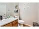 Charming half bathroom with wood accents, decorative shelves, and modern fixtures at 9615 Lansing Cir, Commerce City, CO 80022