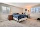 Comfortable bedroom with natural light from two windows and neutral carpeting at 9615 Lansing Cir, Commerce City, CO 80022