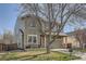 Two-story home with well-maintained lawn and two-car garage, featuring a red front door and stone accents at 9615 Lansing Cir, Commerce City, CO 80022
