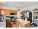 Bright kitchen with stainless appliances, wood cabinets, butcher block island and pantry at 9615 Lansing Cir, Commerce City, CO 80022