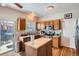 Cozy kitchen features wood cabinets, stainless steel appliances, and a butcher block island at 9615 Lansing Cir, Commerce City, CO 80022