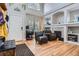 Inviting living room featuring a fireplace, high ceilings, hardwood floors, and neutral paint at 9615 Lansing Cir, Commerce City, CO 80022