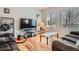 Comfortable living room with hardwood floors, large TV, and lots of natural light at 9615 Lansing Cir, Commerce City, CO 80022