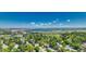 Expansive aerial view showcasing a neighborhood with lush trees and a distant lake at 5071 S Boston St, Greenwood Village, CO 80111