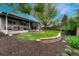 Beautiful backyard with a covered patio, seating area, mature trees, and a well-maintained lawn, perfect for outdoor enjoyment at 5071 S Boston St, Greenwood Village, CO 80111