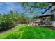 Spacious backyard featuring a covered patio with outdoor seating, grill, lush green lawn, and a privacy fence at 5071 S Boston St, Greenwood Village, CO 80111