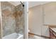 Tiled shower and tub features stylish fixtures and neutral colors, offering a modern and relaxing bathing experience at 5071 S Boston St, Greenwood Village, CO 80111