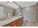 Elegant bathroom with double vanity sinks, granite countertop, tile floors, and a glass-enclosed shower at 5071 S Boston St, Greenwood Village, CO 80111