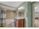 Updated bathroom featuring a shower and bath, tile flooring and granite vanity at 5071 S Boston St, Greenwood Village, CO 80111