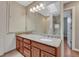 Bathroom features a double sink vanity with granite countertops, large mirror, and a tiled shower/tub combination at 5071 S Boston St, Greenwood Village, CO 80111