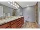 Full bathroom with double sinks, tiled floors and tiled walk-in shower at 5071 S Boston St, Greenwood Village, CO 80111