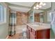 Well-lit bathroom features a single sink vanity with granite countertops, and a shower/tub combination at 5071 S Boston St, Greenwood Village, CO 80111