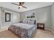 Bright bedroom with ceiling fan, soft carpet and ensuite full bathroom at 5071 S Boston St, Greenwood Village, CO 80111