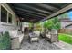 Relaxing covered patio with comfortable wicker furniture, an outdoor ceiling fan, and a heater, creating a cozy outdoor living space at 5071 S Boston St, Greenwood Village, CO 80111