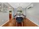 Dining room with contemporary chandelier, open to living area with wood floors at 5071 S Boston St, Greenwood Village, CO 80111