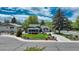 Charming home showcasing well-maintained landscaping, mature trees, and a blue sky at 5071 S Boston St, Greenwood Village, CO 80111