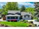Charming single-Gathering home featuring mature trees and a well-manicured lawn with flower beds at 5071 S Boston St, Greenwood Village, CO 80111