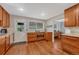 Bright kitchen with stainless appliances, and wood cabinets with granite countertops that leads to dining area at 5071 S Boston St, Greenwood Village, CO 80111